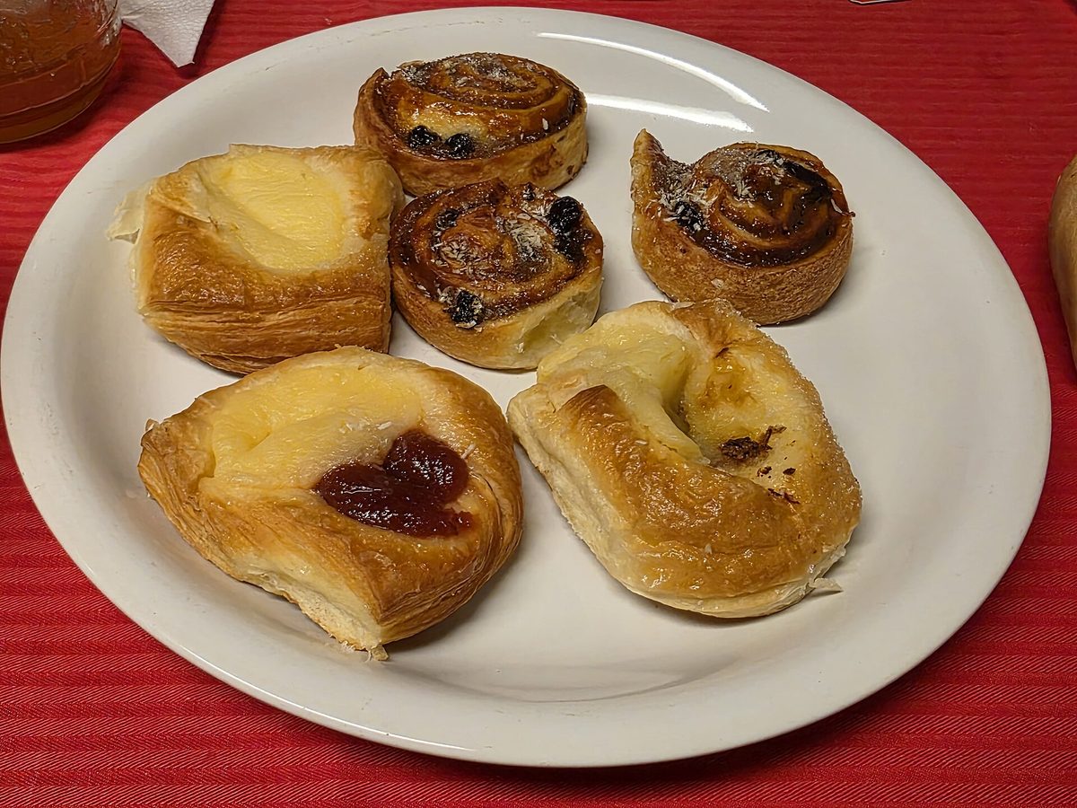 A plate of assorted Argentine facturas, the sweet pastries sold alongside medialunas in a Buenos Aires panaderia