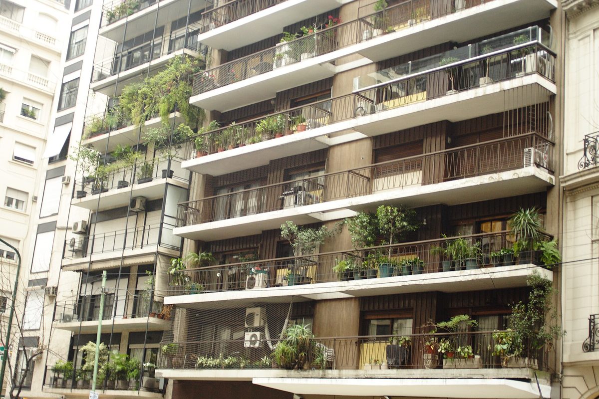 Balcony-lined apartment buildings on a residential street in Recoleta, Buenos Aires