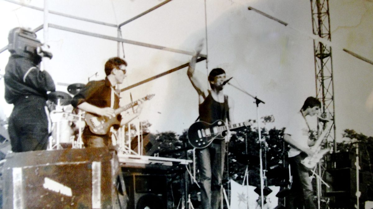 Rock band playing electric guitars on stage at a concert
