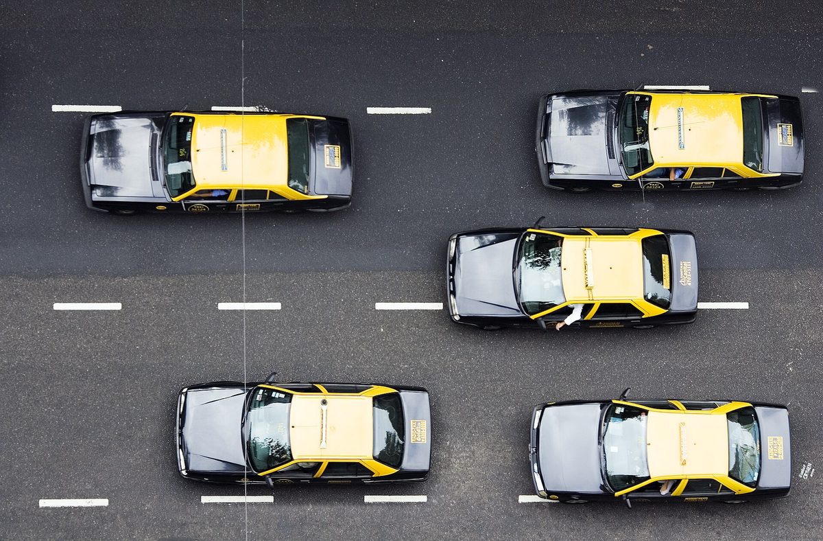 Buenos Aires black-and-yellow taxis seen from above on a city boulevard