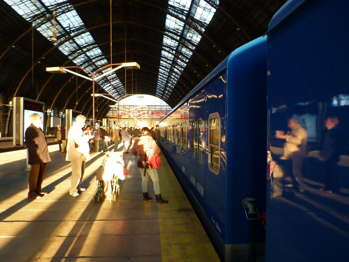 A modern blue Mitre line train under the glass-and-iron roof of Retiro station, the lead terminal in this buenos aires trains guide