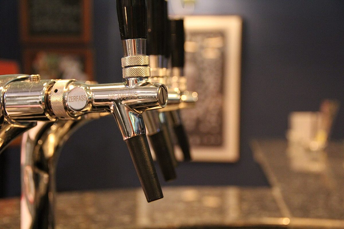 A row of beer taps at a brewpub pouring Argentine craft beer