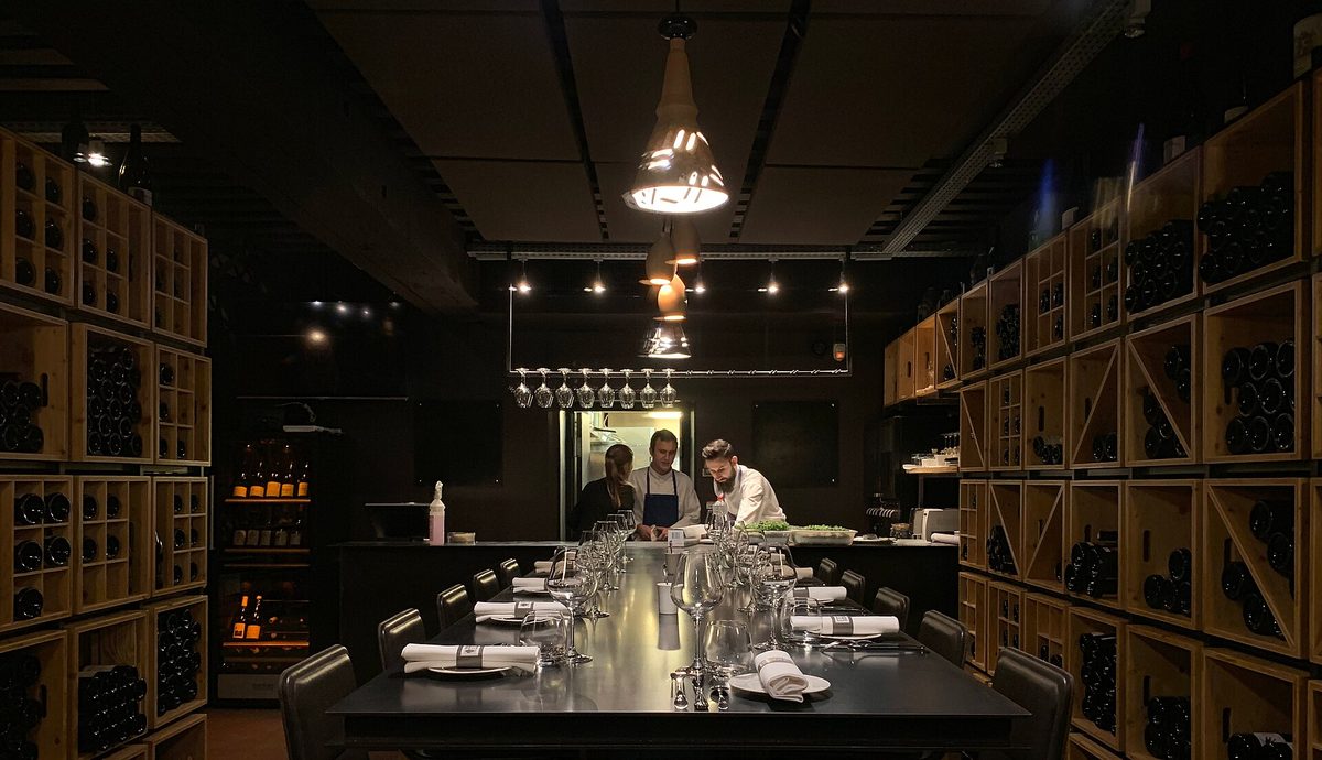 A cosy wine bar like those that make up the Buenos Aires wine bars scene, with bottles lining the wall