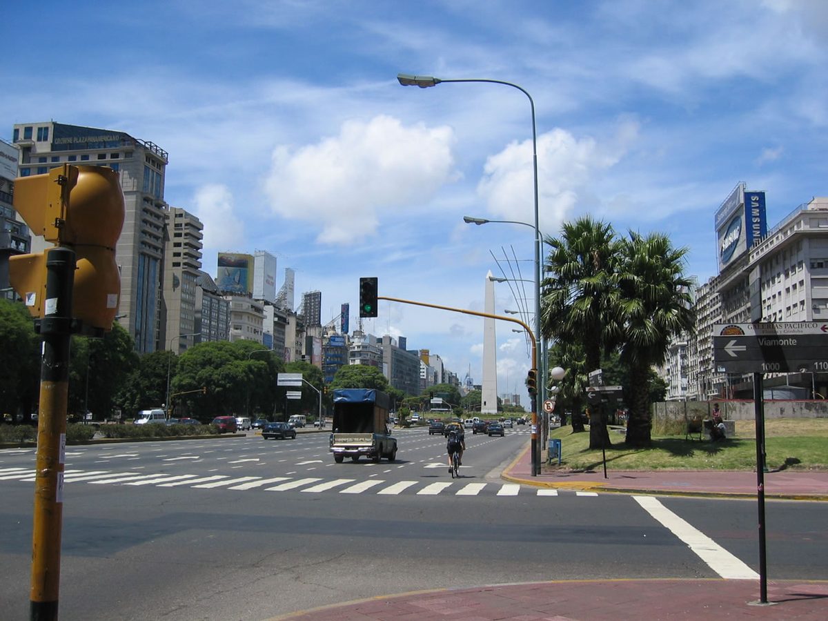 Multi-lane traffic and the Obelisco on Avenida 9 de Julio, the downtown congestion a car rental Buenos Aires drivers must navigate