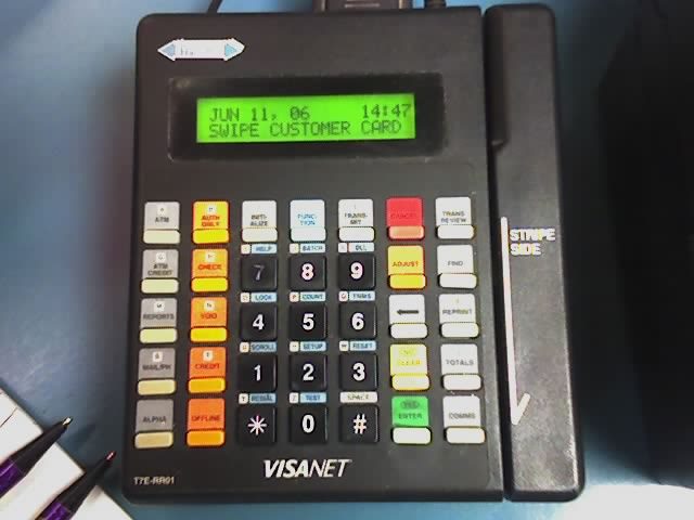 A card payment terminal prompting to swipe a customer card