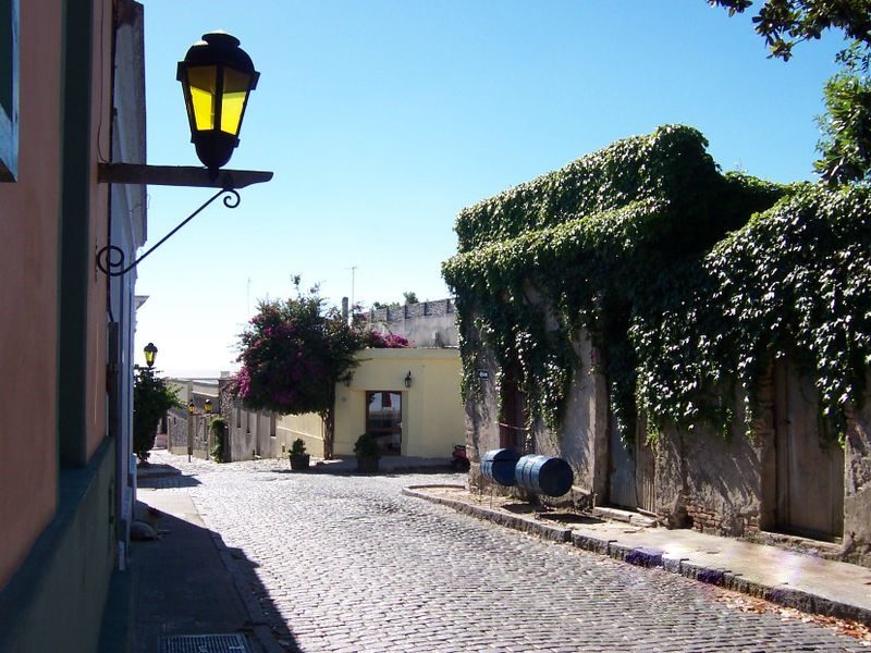Charming cobbled street with a hanging lantern and bougainvillea in Colonia del Sacramento, Uruguay
