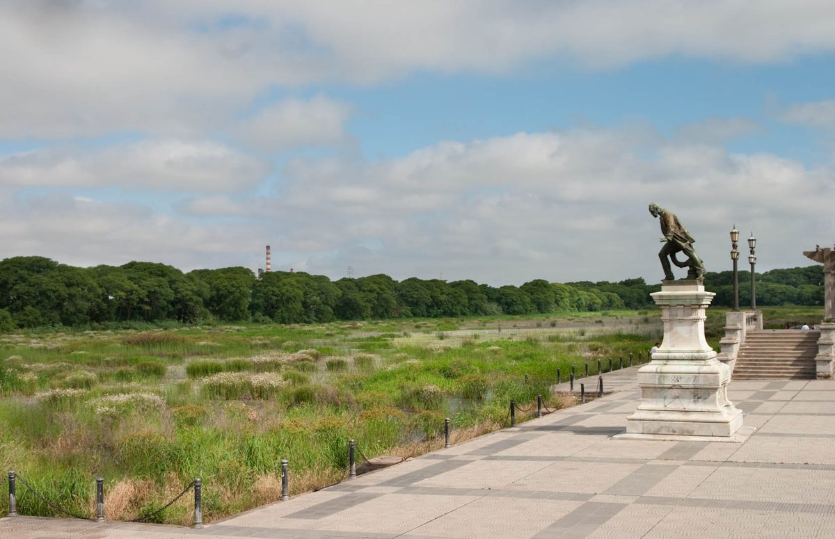 Wide checkerboard-paved Costanera promenade beside the Reserva Ecologica in Buenos Aires, ideal for relaxed cycling