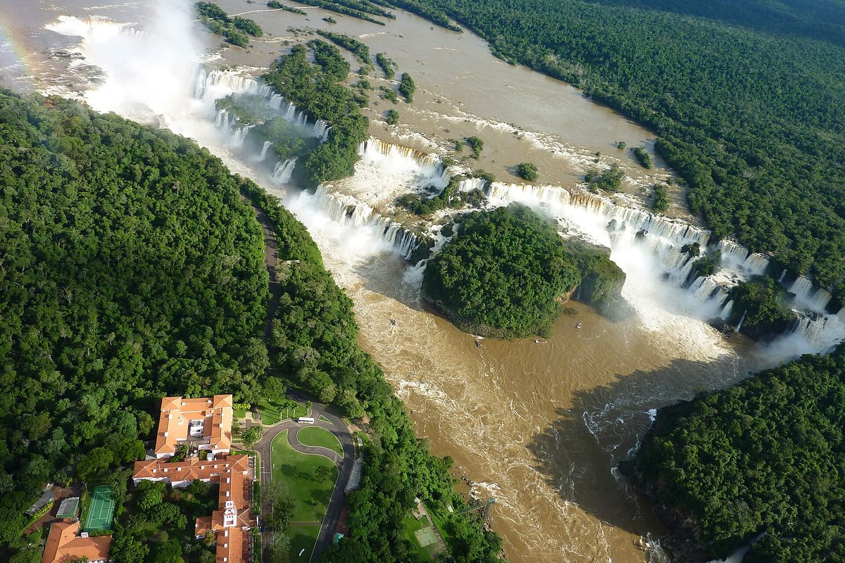 Aerial view of the Iguazu Falls horseshoe with surrounding jungle and a lodge on the Argentina Brazil border