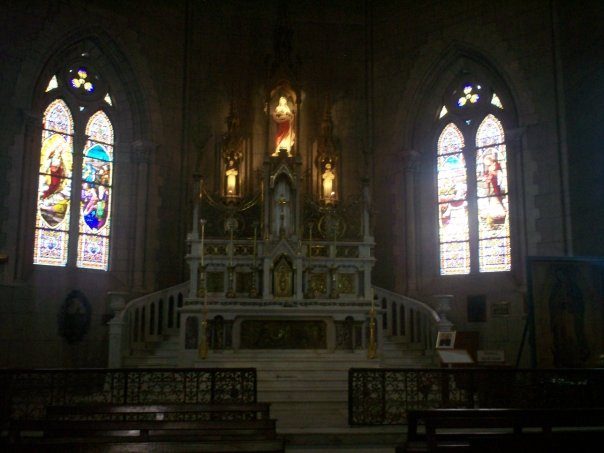 The altar and stained-glass nave inside the Basilica de Luján