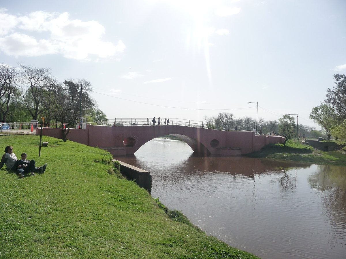 The pink Puente Viejo bridge over the Rio Areco on a san antonio de areco day trip from buenos aires