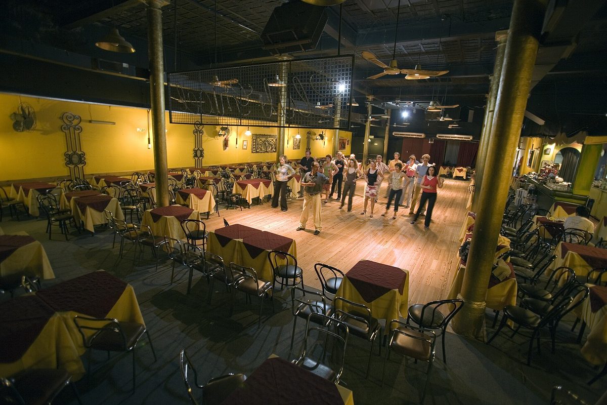 A group tango lesson in Buenos Aires with students learning the basic steps