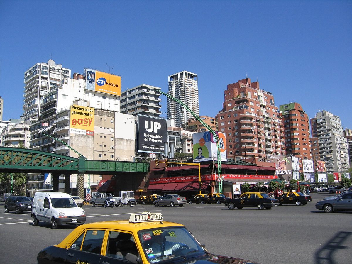 Black-and-yellow taxis on a busy Buenos Aires street in Palermo, a common alternative to ride apps