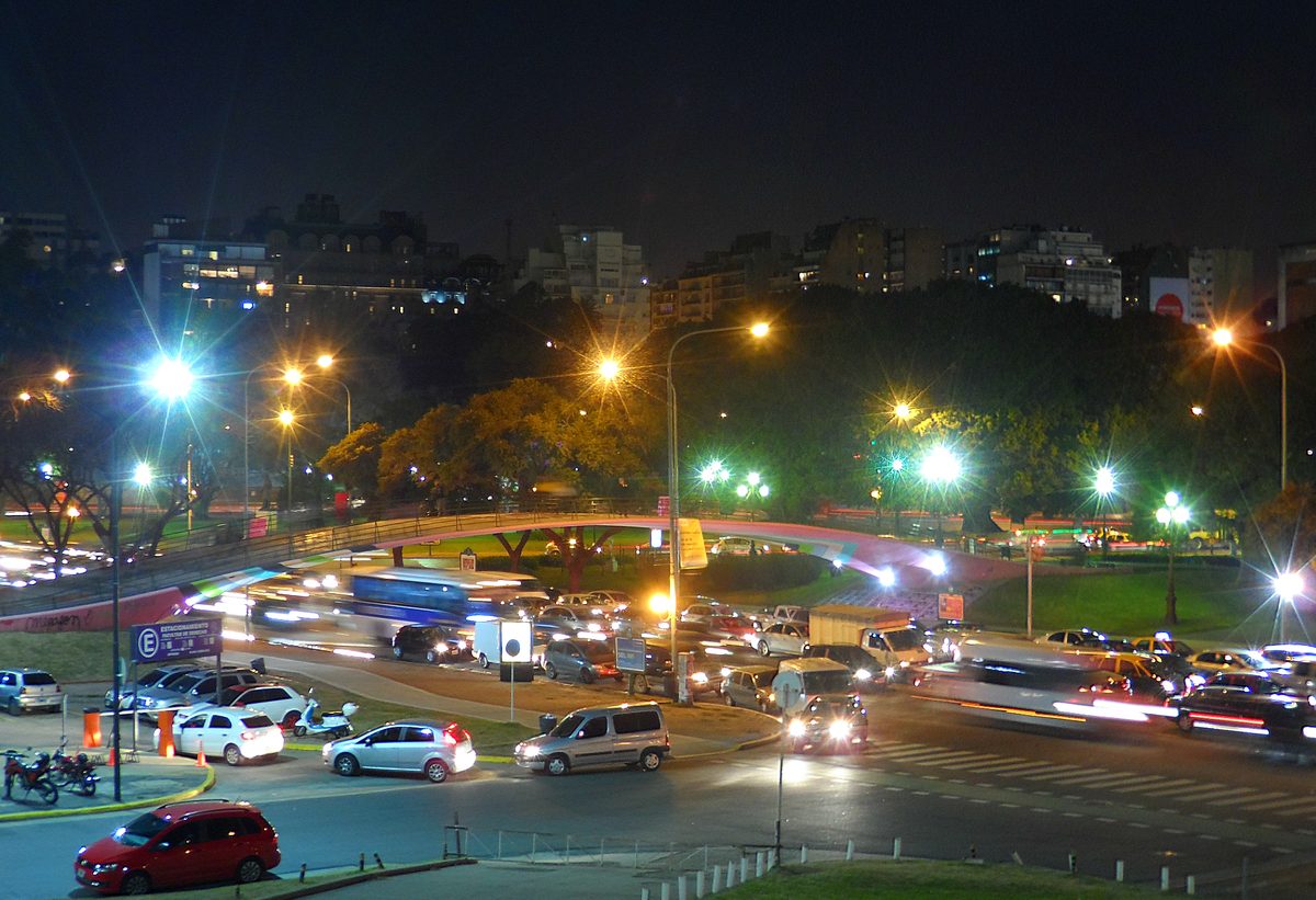 A busy Buenos Aires avenue glowing at night near Recoleta, where central nights out are an easy walk or short taxi away